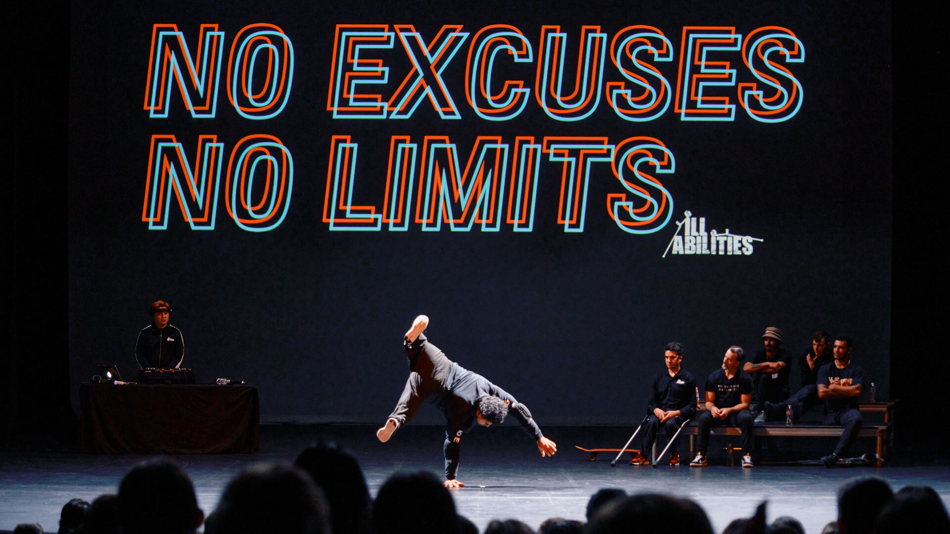 A backdrop on a stage reads 